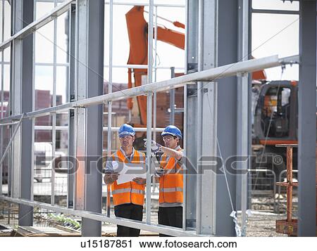 Construction workers reading blueprints View Large Photo Image Stock Image - Construction workers reading blueprints. Fotosearch