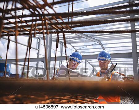 Construction workers reading blueprints View Large Photo Image Stock Photo - Construction workers reading blueprints. Fotosearch