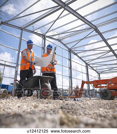 Stock Photography - Construction workers reading blueprints. Fotosearch