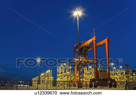 Stock Image - Container crane machinery in shipyard. Fotosearch