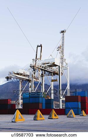 Containers and cranes in shipyard View Large Photo Image Stock Image - Containers and cranes in shipyard. Fotosearch