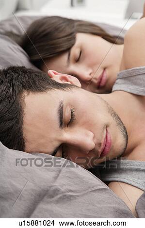 Couple asleep in bed together View Large Photo Image Picture - Couple asleep in bed together. Fotosearch