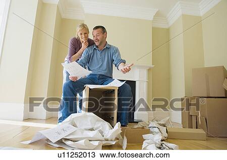 Couple building cabinet in new home View Large Photo Image Stock Image - Couple building cabinet in new home. Fotosearch