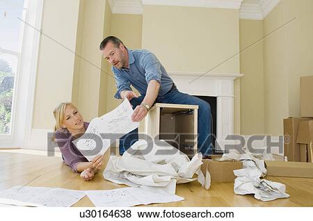 Couple building cabinet in new home View Large Photo Image Stock Photo - Couple building cabinet in new home. Fotosearch