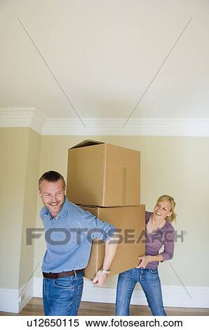 Couple carrying cardboard boxes View Large Photo Image Stock Photography - Couple carrying cardboard boxes. Fotosearch