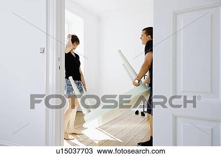 Couple carrying table in new home View Large Photo Image Stock Image - Couple carrying table in new home. Fotosearch