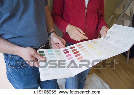 Stock Photography - Couple choosing paint colors in new home. Fotosearch