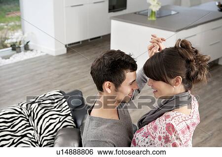 Stock Photograph - Couple dancing in living room. Fotosearch