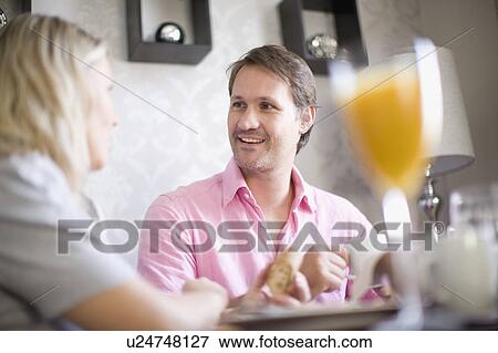 Stock Photo - Couple drinking coffee at breakfast. Fotosearch