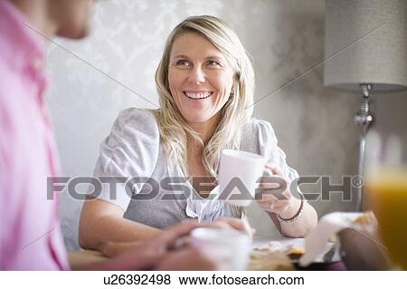 Stock Photo - Couple drinking coffee at breakfast. Fotosearch