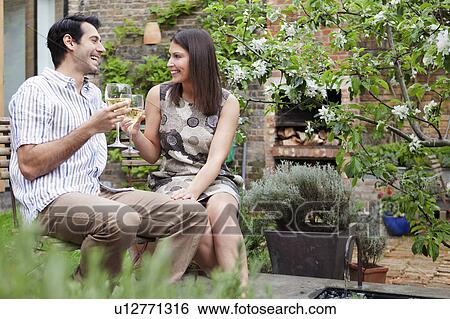 Couple drinking wine together outdoors View Large Photo Image Stock Photograph - Couple drinking wine together outdoors. Fotosearch