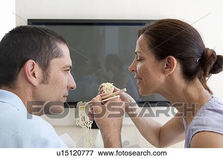 Couple eating Chinese take out View Large Photo Image Stock Photo - Couple eating Chinese take out. Fotosearch