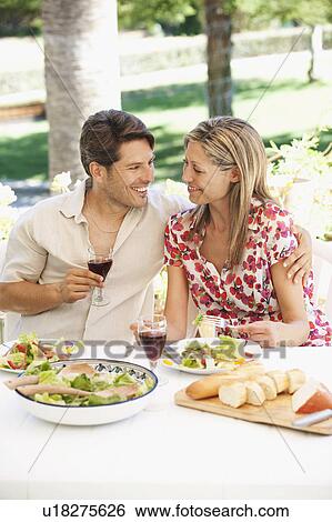 Stock Photograph - Couple eating outdoors. Fotosearch
