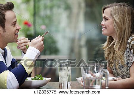 Stock Photography - Couple eating together at home. Fotosearch