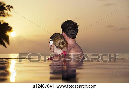 Couple embracing in infinity pool View Large Photo Image Stock Image - Couple embracing in infinity pool. Fotosearch