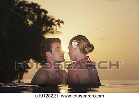 Couple embracing in infinity pool View Large Photo Image Stock Image - Couple embracing in infinity pool. Fotosearch