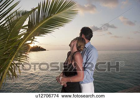 Picture - Couple embracing on dock. Fotosearch