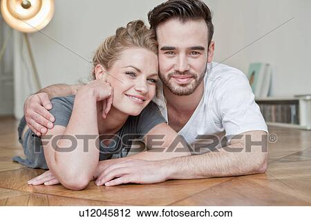 Couple embracing on floor View Large Photo Image Stock Image - Couple embracing on floor. Fotosearch