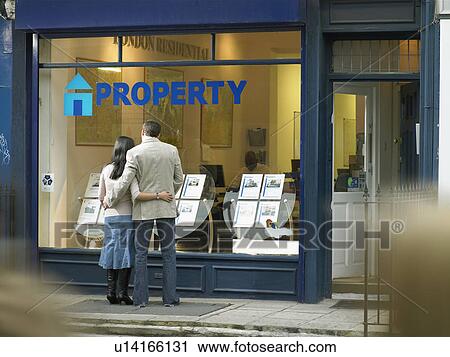 Couple examining real estate for sale View Large Photo Image Stock Image - Couple examining real estate for sale. Fotosearch