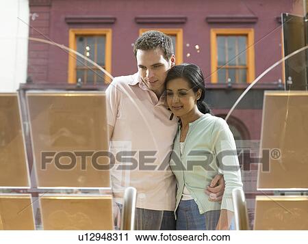 Couple examining window display View Large Photo Image Stock Image - Couple examining window display. Fotosearch
