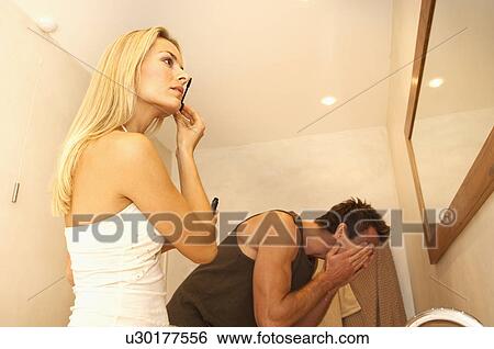 Stock Photograph - Couple grooming in bathroom. Fotosearch