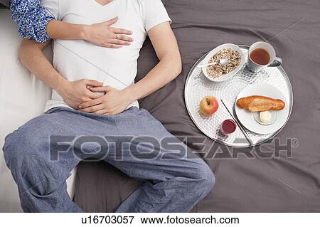 Couple having breakfast in bed View Large Photo Image Stock Photo - Couple having breakfast in bed. Fotosearch