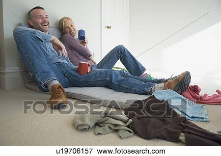 Couple having coffee in new home View Large Photo Image Stock Photo - Couple having coffee in new home. Fotosearch