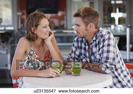 Couple having drinks at cafe View Large Photo Image Stock Photo - Couple having drinks at cafe. Fotosearch