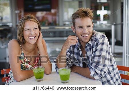 Couple having drinks at cafe View Large Photo Image Stock Photograph - Couple having drinks at cafe. Fotosearch