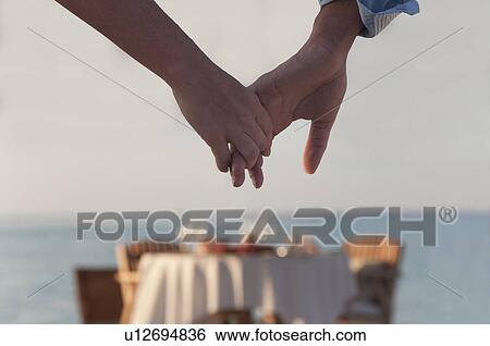 Stock Photograph - Couple holding hands . Fotosearch