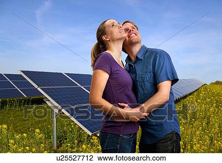Couple hugging by solar panels View Large Photo Image Stock Image - Couple hugging by solar panels. Fotosearch