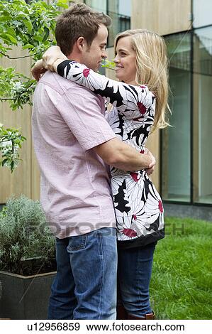 Couple hugging in backyard View Large Photo Image Stock Photo - Couple hugging in backyard. Fotosearch