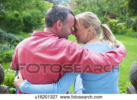 Couple hugging in backyard View Large Photo Image Stock Photo - Couple hugging in backyard. Fotosearch