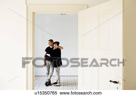 Couple hugging in new home View Large Photo Image Stock Photography - Couple hugging in new home. Fotosearch