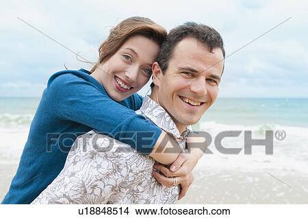Picture - Couple hugging on beach. Fotosearch
