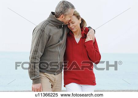 Couple hugging on beach View Large Photo Image Stock Photography - Couple hugging on beach. Fotosearch