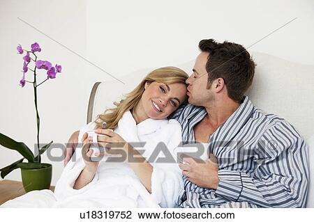 Couple in bathrobes drinking coffee View Large Photo Image Stock Image - Couple in bathrobes drinking coffee. Fotosearch