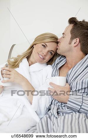 Couple in bathrobes drinking coffee View Large Photo Image Stock Photo - Couple in bathrobes drinking coffee. Fotosearch
