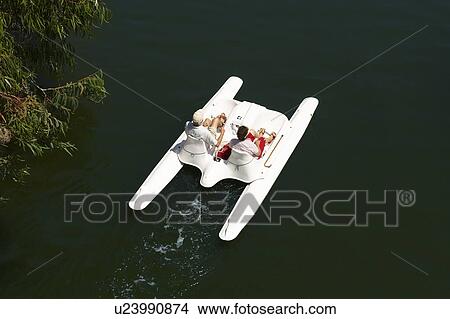 Couple in paddle boat on lake View Large Photo Image Picture - Couple in paddle boat on lake. Fotosearch