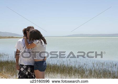 Stock Photograph - Couple kissing on beach. Fotosearch