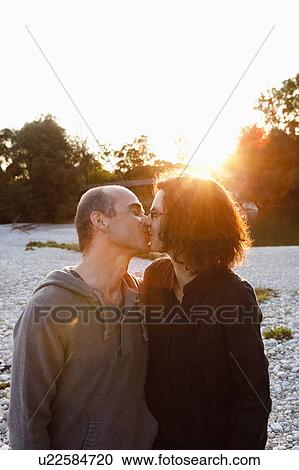 Stock Image - Couple kissing outdoors. Fotosearch