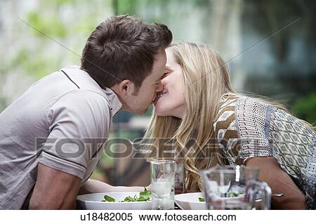 Couple kissing over meal at home View Large Photo Image Stock Photography - Couple kissing over meal at home. Fotosearch