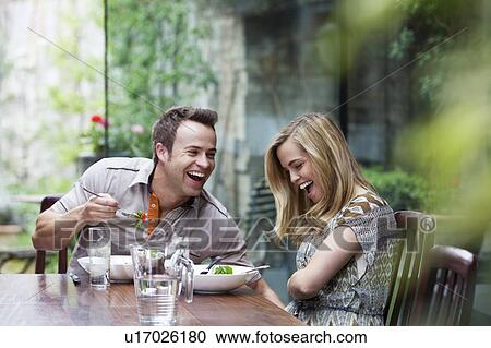 Couple laughing over meal at home View Large Photo Image Stock Image - Couple laughing over meal at home. Fotosearch