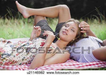 Couple laying in field together View Large Photo Image Stock Image - Couple laying in field together. Fotosearch