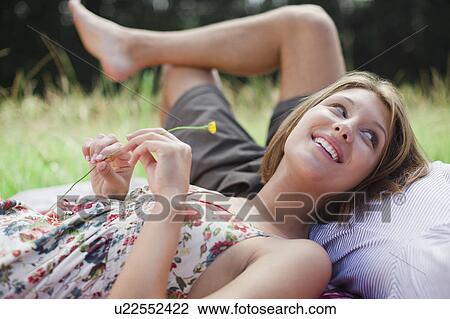 Couple laying in field together View Large Photo Image Stock Image - Couple laying in field together. Fotosearch