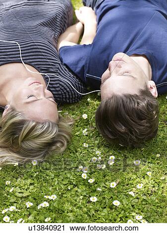 Couple listening to headphones together View Large Photo Image Stock Image - Couple listening to headphones together. Fotosearch