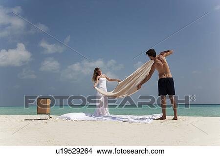 Couple making bed on beach View Large Photo Image Picture - Couple making bed on beach. Fotosearch