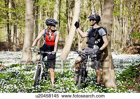 Couple mountain biking together View Large Photo Image Stock Photography - Couple mountain biking together. Fotosearch