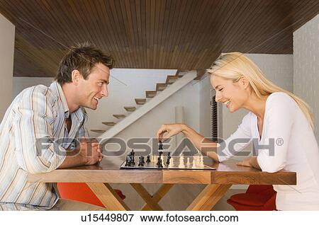 Stock Photo - Couple playing chess together. Fotosearch