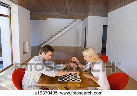 Stock Photography - Couple playing chess together. Fotosearch